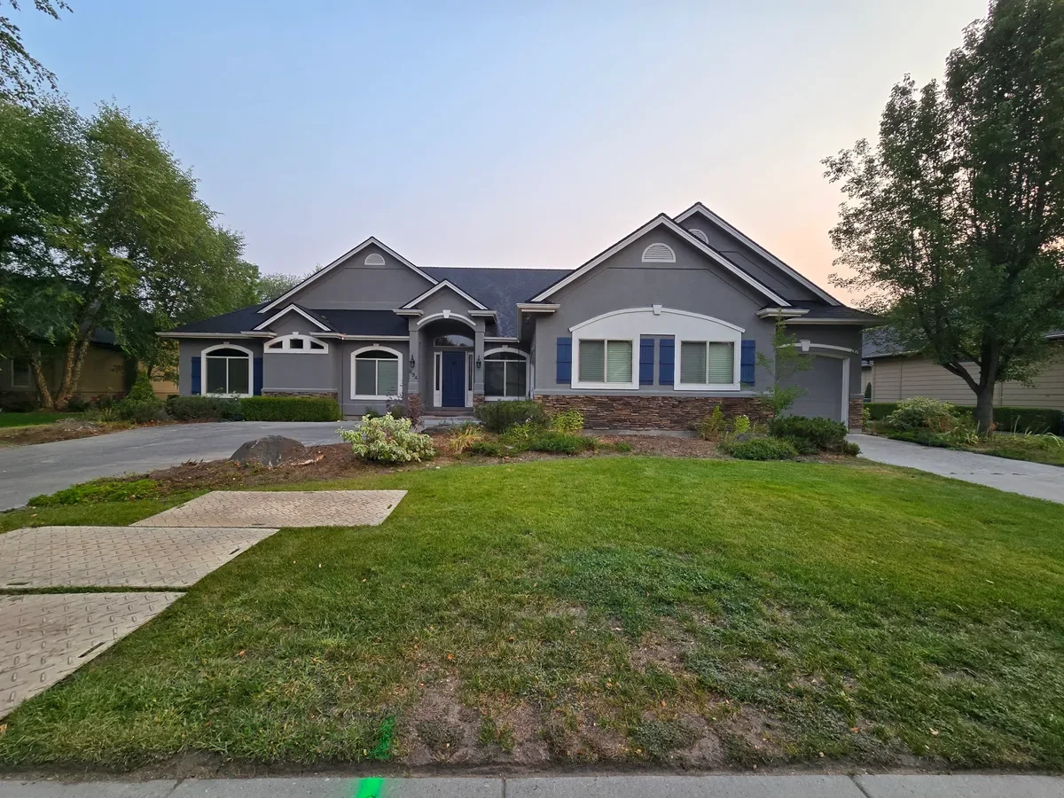 Mature trees and shrubs framing upscale home in Caldwell Idaho